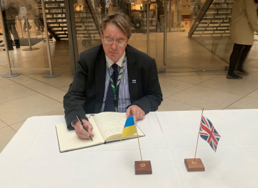 John signing book of solidarity